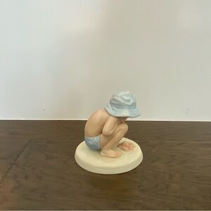 Porcelain Figurine of a Child in Blue Hat
